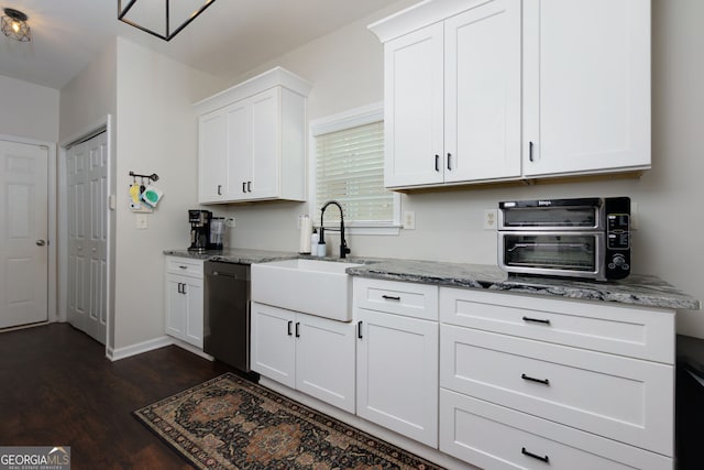 kitchen featuring a sink, dishwasher, dark wood-style floors, light stone countertops, and white cabinetry