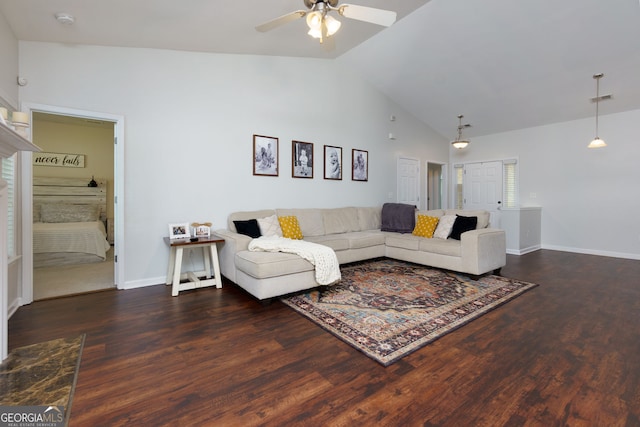 living area with ceiling fan, vaulted ceiling, wood finished floors, and baseboards