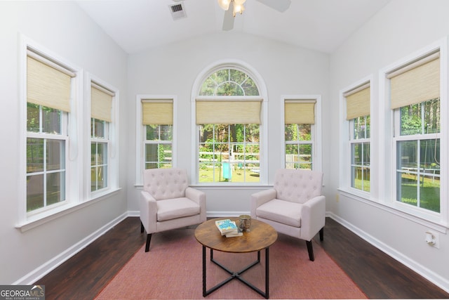 sunroom / solarium featuring wood finished floors, lofted ceiling, and baseboards