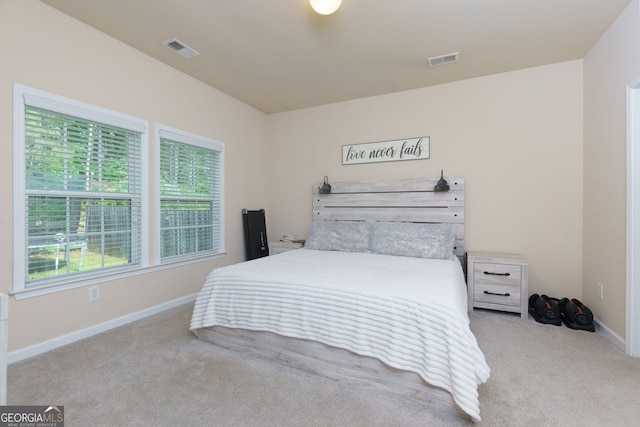 bedroom with multiple windows, carpet flooring, and baseboards