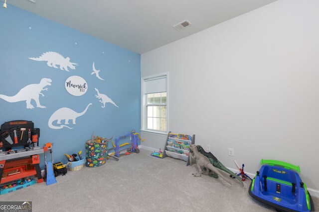 recreation room with carpet floors and baseboards