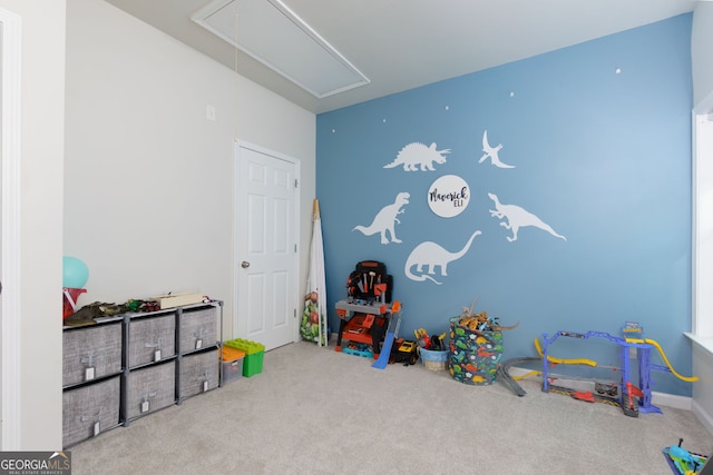 rec room featuring attic access and carpet flooring