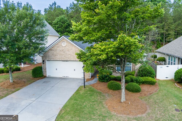 view of front of house featuring brick siding, concrete driveway, and a garage