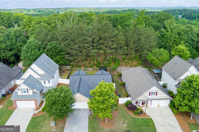 aerial perspective of suburban area featuring a heavily wooded area