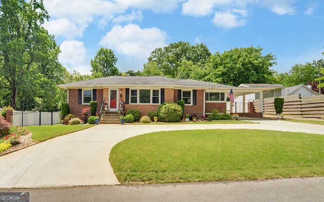 ranch-style house featuring curved driveway, brick siding, and an attached carport