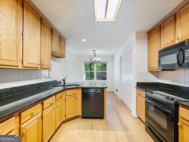 2910 Waverly Place Dr, Dacula, GA 30019 - kitchen with black appliances, a sink, light wood finished floors, a chandelier, and recessed lighting