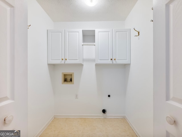 2910 Waverly Place Dr, Dacula, GA 30019 - washroom with washer hookup, electric dryer hookup, cabinet space, baseboards, and a textured ceiling