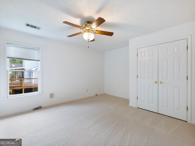 2910 Waverly Place Dr, Dacula, GA 30019 - unfurnished bedroom featuring light colored carpet, a closet, ceiling fan, and baseboards
