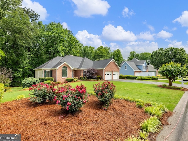 2910 Waverly Place Dr, Dacula, GA 30019 - view of front of home featuring a garage, a front lawn, driveway, and brick siding