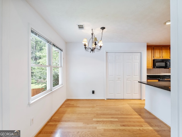 2910 Waverly Place Dr, Dacula, GA 30019 - unfurnished dining area featuring light wood-style floors, a chandelier, and baseboards