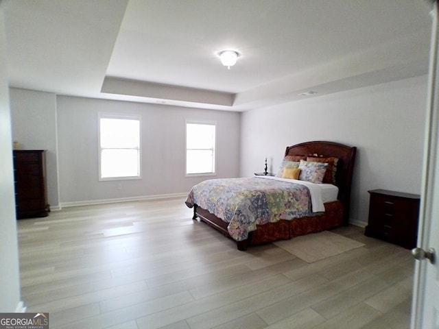 3943 Ridge Grove Way, Suwanee, GA 30024 - bedroom with a raised ceiling, light wood finished floors, and baseboards