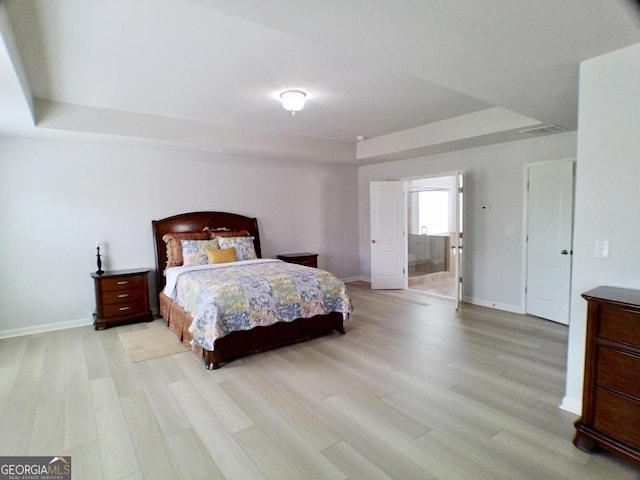 3943 Ridge Grove Way, Suwanee, GA 30024 - bedroom featuring a tray ceiling, light wood-type flooring, and baseboards