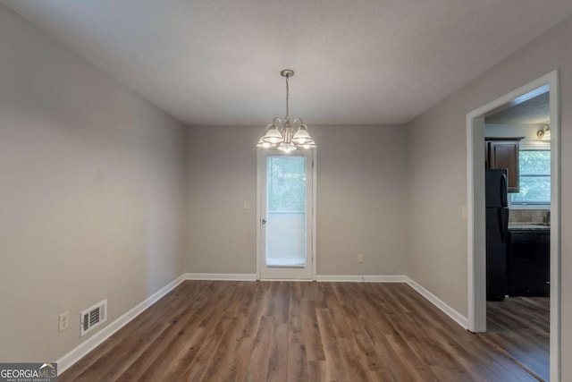 6015 Sumit Ct NW, Kennesaw, GA 30152 - spare room with wood finished floors, baseboards, and a chandelier