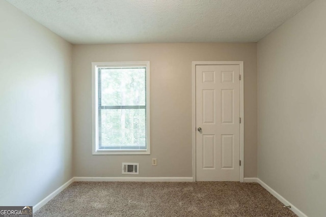 6015 Sumit Ct NW, Kennesaw, GA 30152 - carpeted spare room featuring healthy amount of natural light, a textured ceiling, and baseboards
