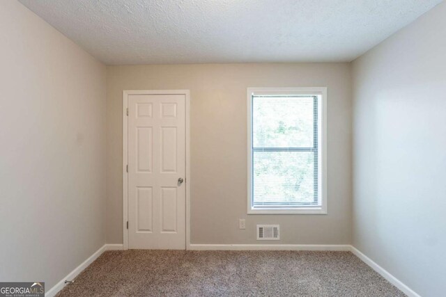 6015 Sumit Ct NW, Kennesaw, GA 30152 - carpeted empty room featuring plenty of natural light, baseboards, and a textured ceiling
