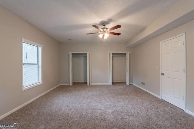 6015 Sumit Ct NW, Kennesaw, GA 30152 - unfurnished bedroom with carpet, multiple closets, baseboards, and ceiling fan