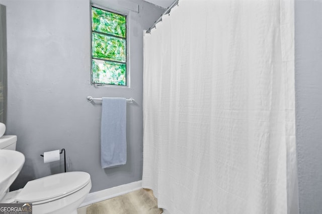 210 Estoria St SE, Atlanta, GA 30316 - bathroom with wood finished floors and a shower with shower curtain