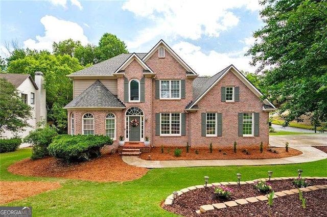 101 Misty Valley Dr, Canton, GA 30114 - view of front of property featuring brick siding, a front yard, and roof with shingles