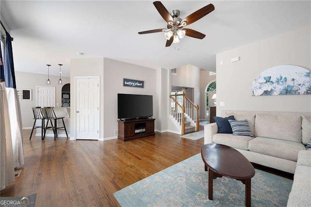 101 Misty Valley Dr, Canton, GA 30114 - living area featuring wood finished floors, ceiling fan, stairway, and baseboards