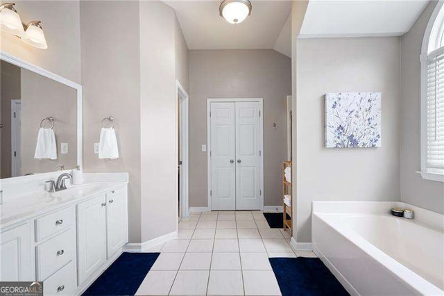 101 Misty Valley Dr, Canton, GA 30114 - bathroom with vanity, tile patterned flooring, baseboards, a bath, and healthy amount of natural light