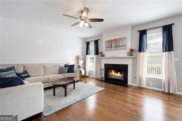101 Misty Valley Dr, Canton, GA 30114 - living area featuring ceiling fan, a lit fireplace, wood finished floors, and healthy amount of natural light
