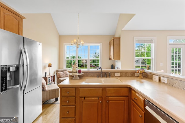85 Majestic Shores Trl, Hartwell, GA 30643 - kitchen with appliances with stainless steel finishes, a sink, a chandelier, light countertops, and light wood-type flooring