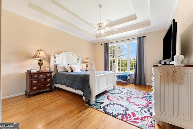 85 Majestic Shores Trl, Hartwell, GA 30643 - bedroom with a tray ceiling, light wood-style flooring, ornamental molding, and ceiling fan