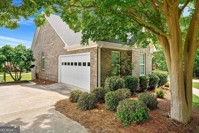 85 Majestic Shores Trl, Hartwell, GA 30643 - view of front of property featuring a shingled roof, brick siding, concrete driveway, and a garage