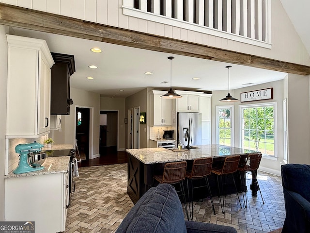 34 Pine Grove Rd, Cartersville, GA 30120 - kitchen with appliances with stainless steel finishes, tasteful backsplash, white cabinetry, recessed lighting, and baseboards