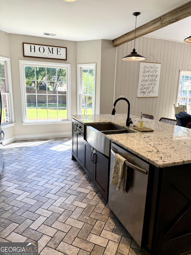 34 Pine Grove Rd, Cartersville, GA 30120 - kitchen with stainless steel dishwasher, a sink, a center island with sink, plenty of natural light, and wooden walls