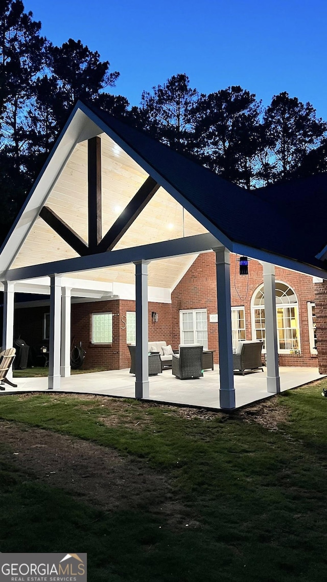 34 Pine Grove Rd, Cartersville, GA 30120 - back of house with an outdoor hangout area, a patio, brick siding, and a carport