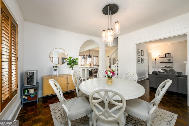 1448 N Highland Ave NE, Atlanta, GA 30306 - dining space featuring stairway, arched walkways, crown molding, and a chandelier