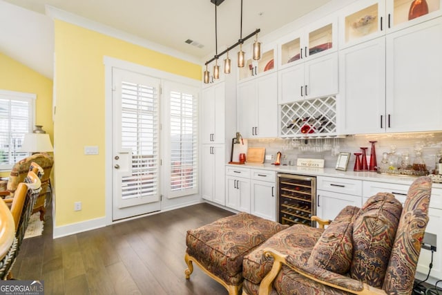 963 S On Main Dr, Woodstock, GA 30188 - indoor dry bar with beverage cooler, backsplash, dark wood finished floors, hanging light fixtures, and baseboards