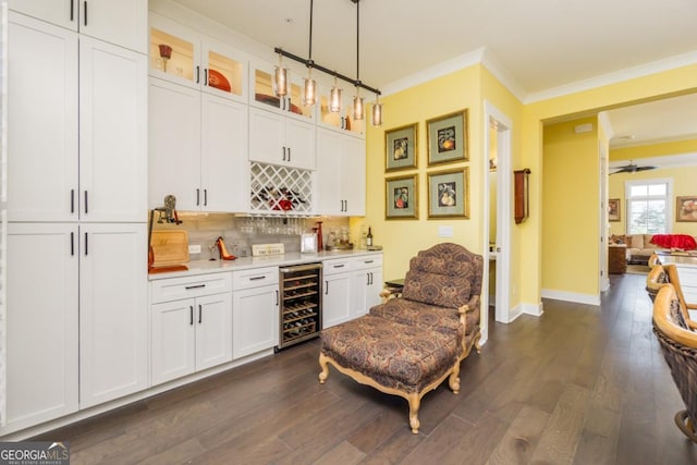 963 S On Main Dr, Woodstock, GA 30188 - indoor wet bar with beverage cooler, crown molding, decorative backsplash, dark wood-style flooring, and baseboards
