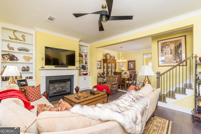 963 S On Main Dr, Woodstock, GA 30188 - living area with a chandelier, dark wood-type flooring, a ceiling fan, stairway, and built in shelves