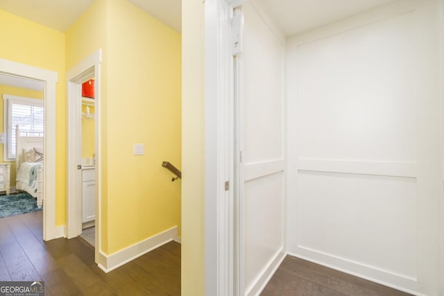 963 S On Main Dr, Woodstock, GA 30188 - corridor with dark wood-style floors, an upstairs landing, and baseboards