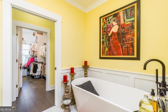 963 S On Main Dr, Woodstock, GA 30188 - full bathroom with wainscoting, a freestanding tub, wood finished floors, and a decorative wall