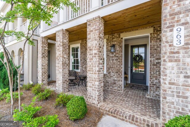 963 S On Main Dr, Woodstock, GA 30188 - property entrance featuring brick siding and a balcony