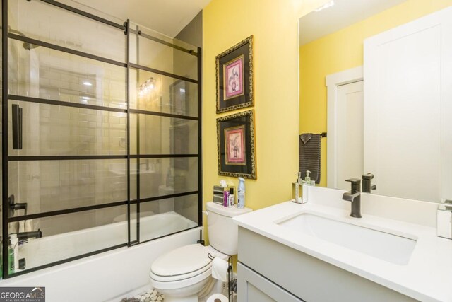 963 S On Main Dr, Woodstock, GA 30188 - full bathroom with toilet, shower / bath combination with glass door, and vanity