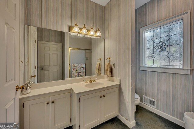 181 Sentinel Pl NE, Marietta, GA 30067 - full bathroom with wallpapered walls, a shower stall, plenty of natural light, baseboards, and toilet