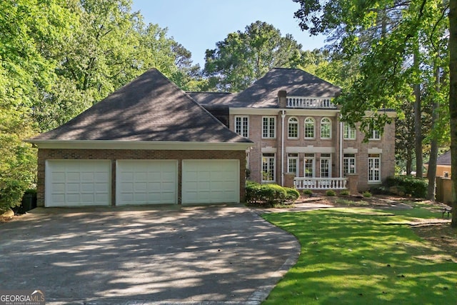 181 Sentinel Pl NE, Marietta, GA 30067 - view of front facade featuring driveway, an attached garage, brick siding, and a front lawn