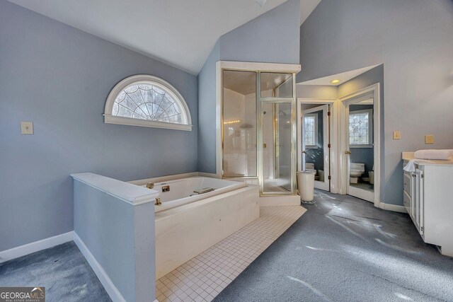 181 Sentinel Pl NE, Marietta, GA 30067 - bathroom with vaulted ceiling, a stall shower, toilet, a bath, and baseboards