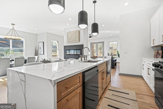 3378 Bachelor St, Atlanta, GA 30344 - kitchen featuring open floor plan, stainless steel dishwasher, a sink, recessed lighting, and light stone countertops