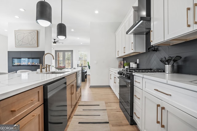 3378 Bachelor St, Atlanta, GA 30344 - kitchen with wall chimney exhaust hood, appliances with stainless steel finishes, a sink, light wood-type flooring, and backsplash