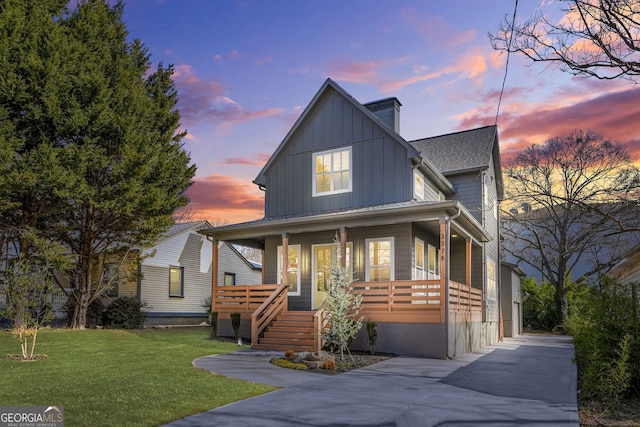 3378 Bachelor St, Atlanta, GA 30344 - view of front facade with covered porch, board and batten siding, and a front yard