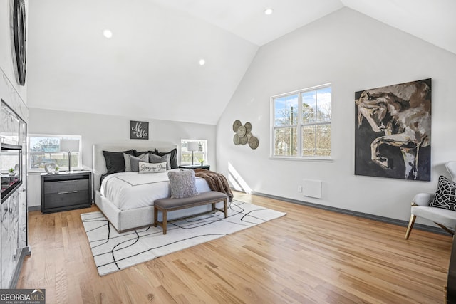 3378 Bachelor St, Atlanta, GA 30344 - bedroom with light wood-type flooring, vaulted ceiling, multiple windows, and recessed lighting