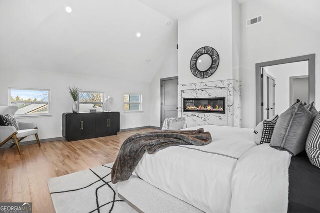 3378 Bachelor St, Atlanta, GA 30344 - bedroom featuring wood finished floors, high vaulted ceiling, baseboards, a premium fireplace, and recessed lighting