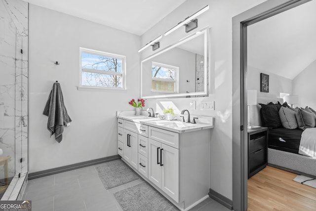 3378 Bachelor St, Atlanta, GA 30344 - bathroom featuring double vanity, a marble finish shower, and baseboards