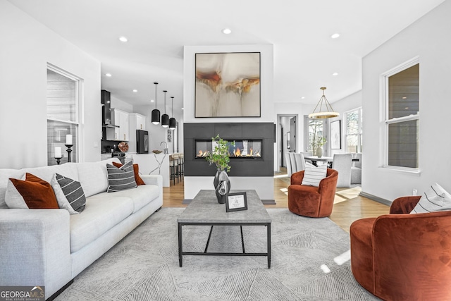 3378 Bachelor St, Atlanta, GA 30344 - living area with light wood-type flooring, recessed lighting, and a glass covered fireplace