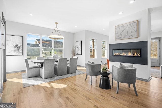 3378 Bachelor St, Atlanta, GA 30344 - dining space featuring light wood finished floors, recessed lighting, a glass covered fireplace, and baseboards